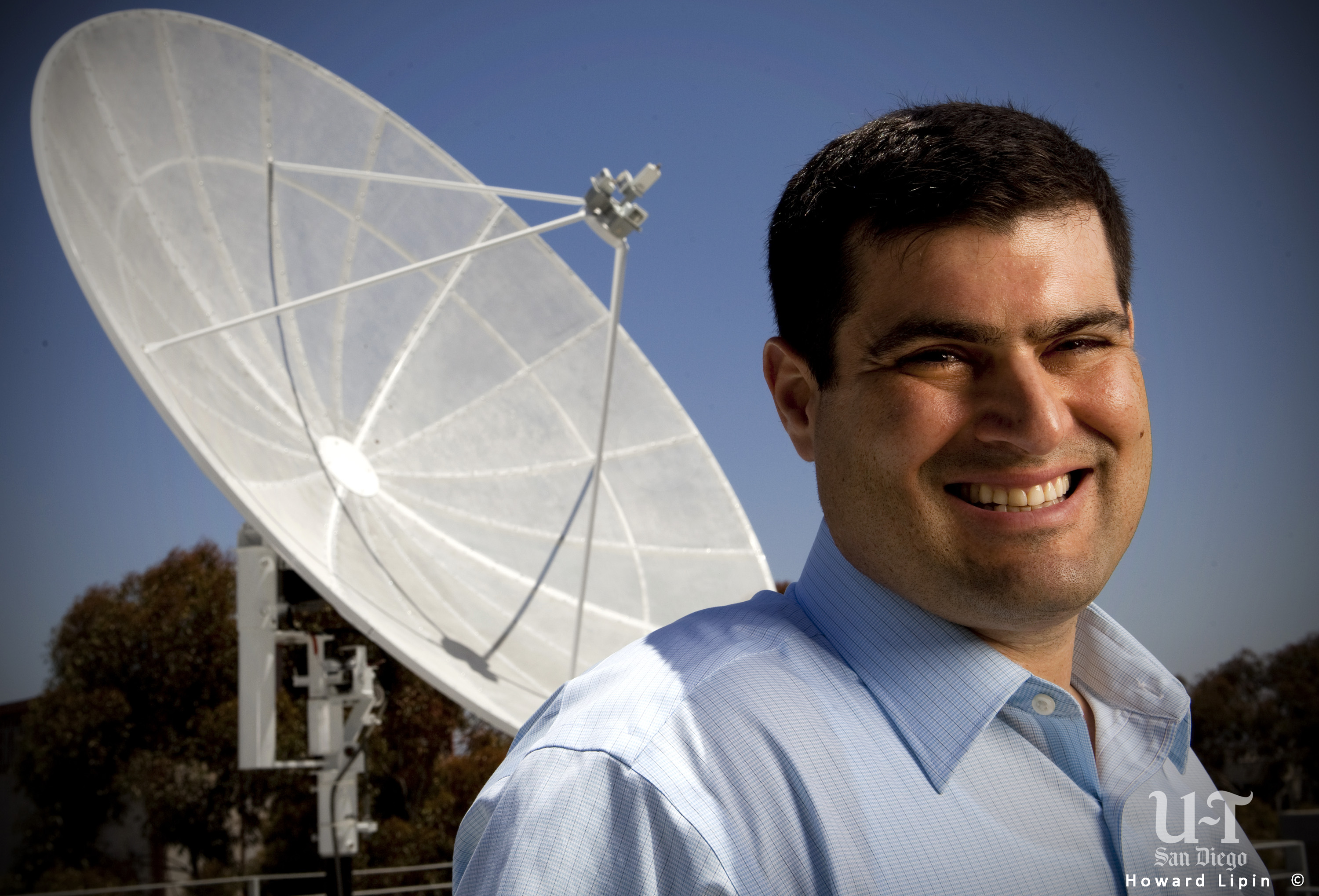 University of California San Diego Astrophysicist Brian Keating, with a radio telescope at the university.